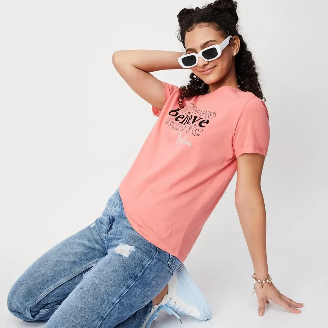 A female professional wearing a tailored custom made uniform t-shirt, designed for comfort and corporate branding in Malaysia.