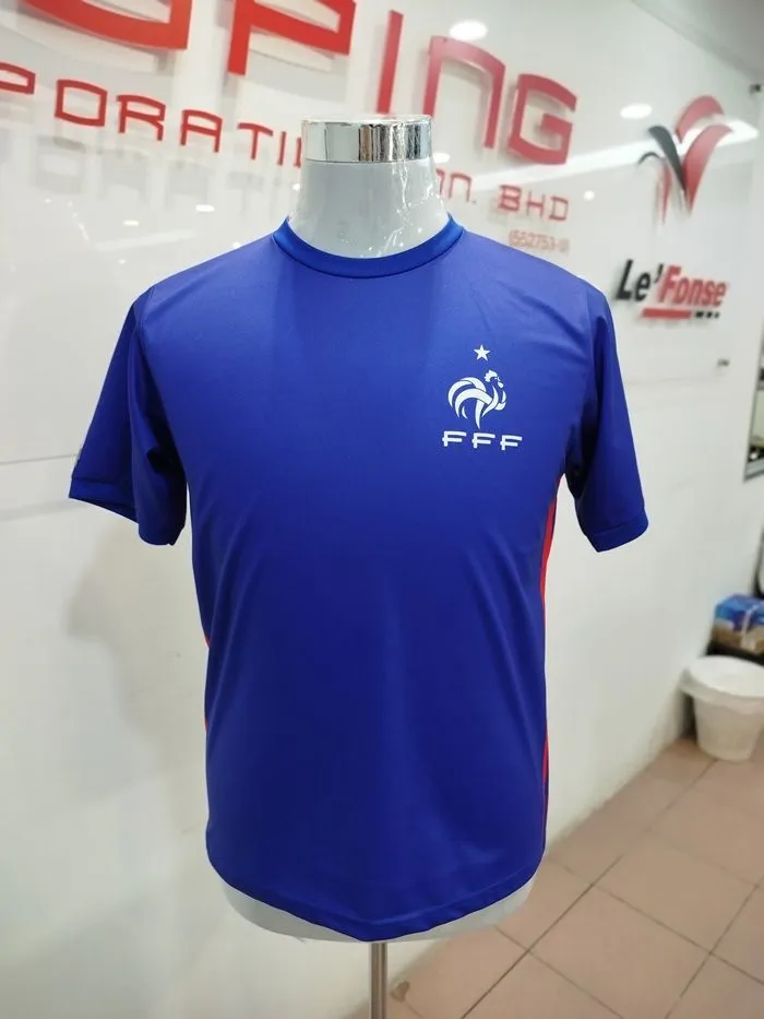 Front view of a custom blue football jersey on a mannequin featuring a white team crest and red side stripe details.