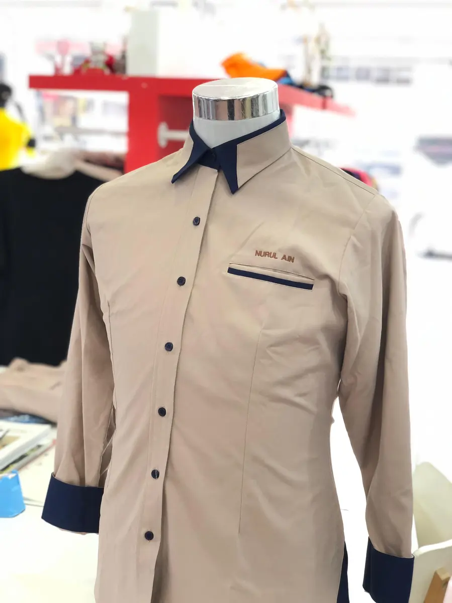 A premium corporate shirt manufactured by a leading custom made uniform supplier in malaysia, showcasing high-quality stitching and professional design for businesses.